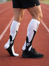 Runner wearing RESFIT Advanced Compression Socks on track