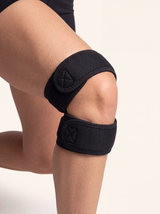 RESFIT Dual Knee Strap worn on visible knee with open patella support during athletic recovery