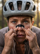 Athlete applying RESFIT Sport & Night Nasal Strips before cycling training