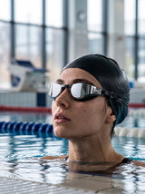 Swimmer wearing YLIKE mirrored swimming goggles in indoor pool