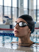 Swimmer wearing YLIKE mirrored swimming goggles in indoor pool
